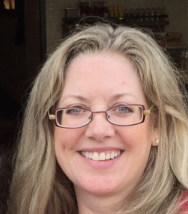 Smiling woman with glasses and blonde hair