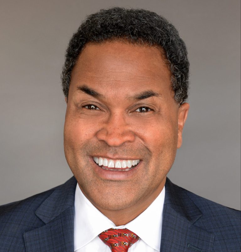 Smiling man in suit with red tie