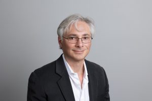 Smiling man in suit and glasses