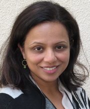 Smiling woman with dark hair and earrings